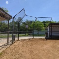 Youth baseball field dugouts and backstop.
