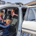 Child sits in driver's seat of Sheriff's vehicle during a day care visit.